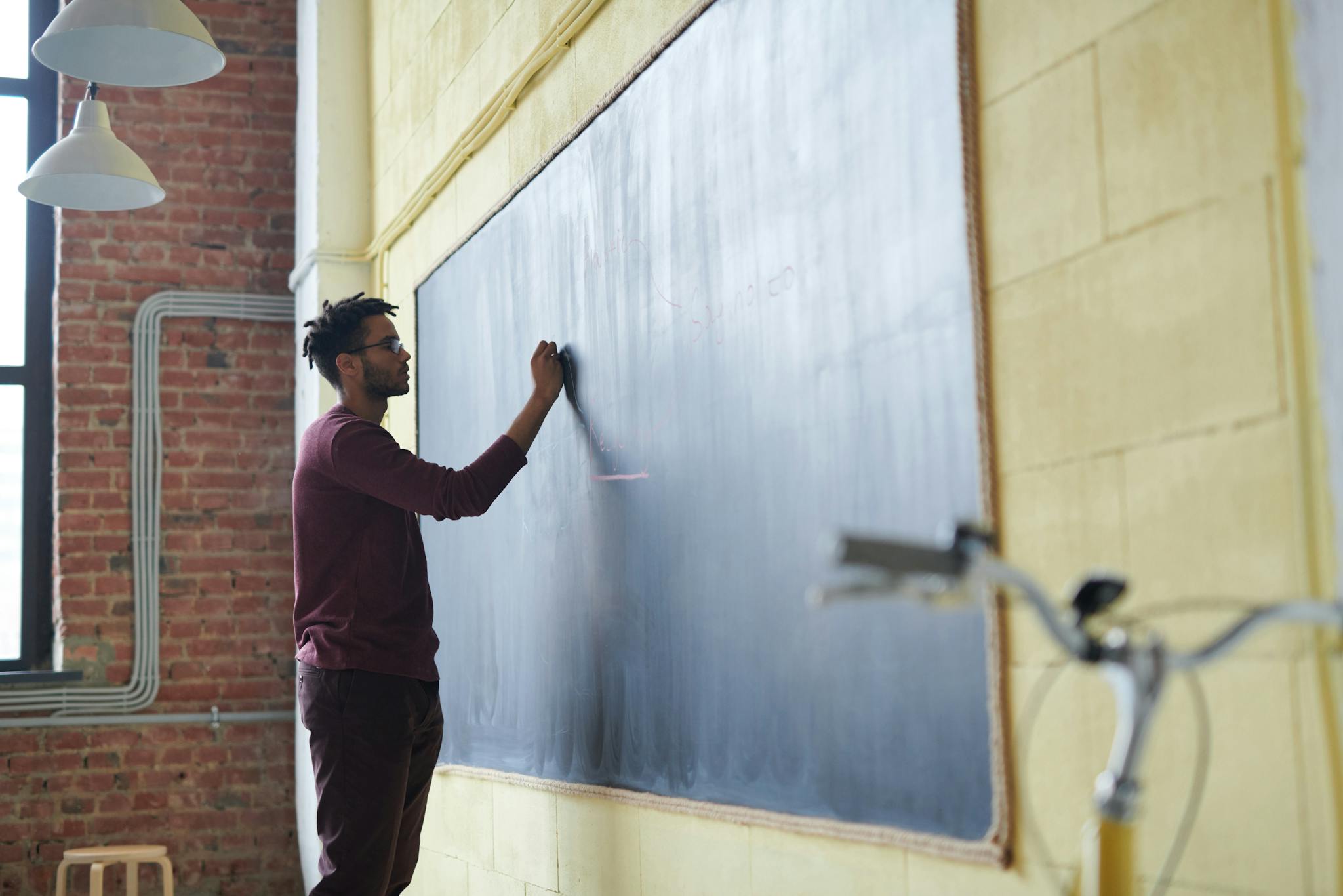 Man Writing on a Blackboard